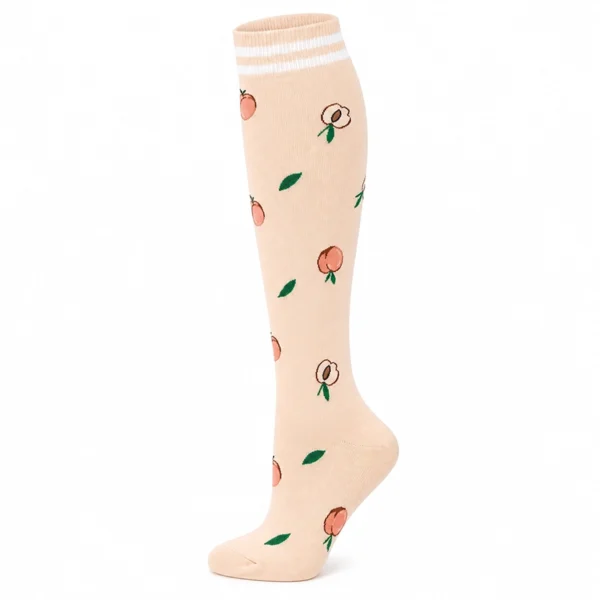 Chaussettes de contention beige clair motif pêches fruitées, haut côtelé à rayures.